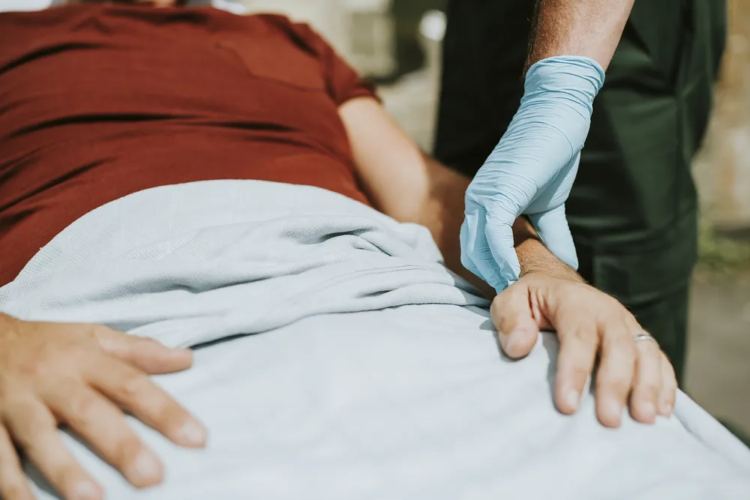 Nurse checking pulse of elderly man